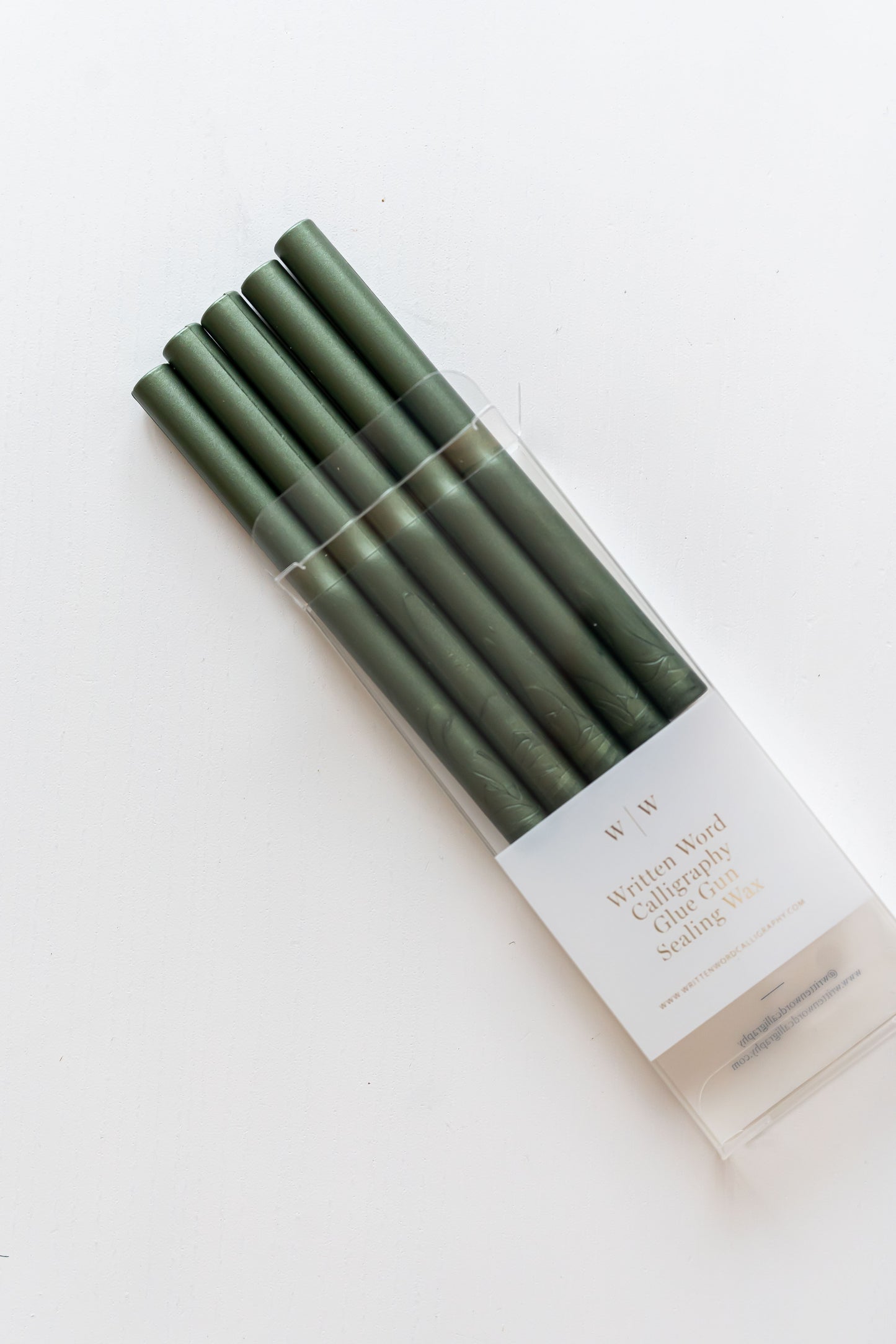 Five emerald green sealing wax sticks packaged for glue gun use, ideal for creating wax seals on wedding invitations, Christmas cards, journals, and stationery.