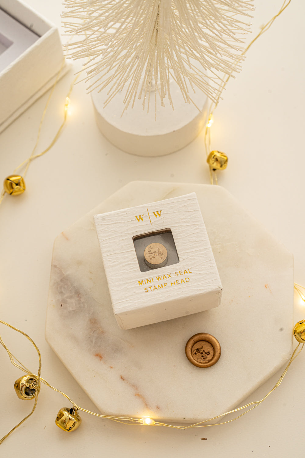 Boxed mini wax seal stamp with musical notes design and gold wax impression, part of Written Word Calligraphyโs Holiday Collection.