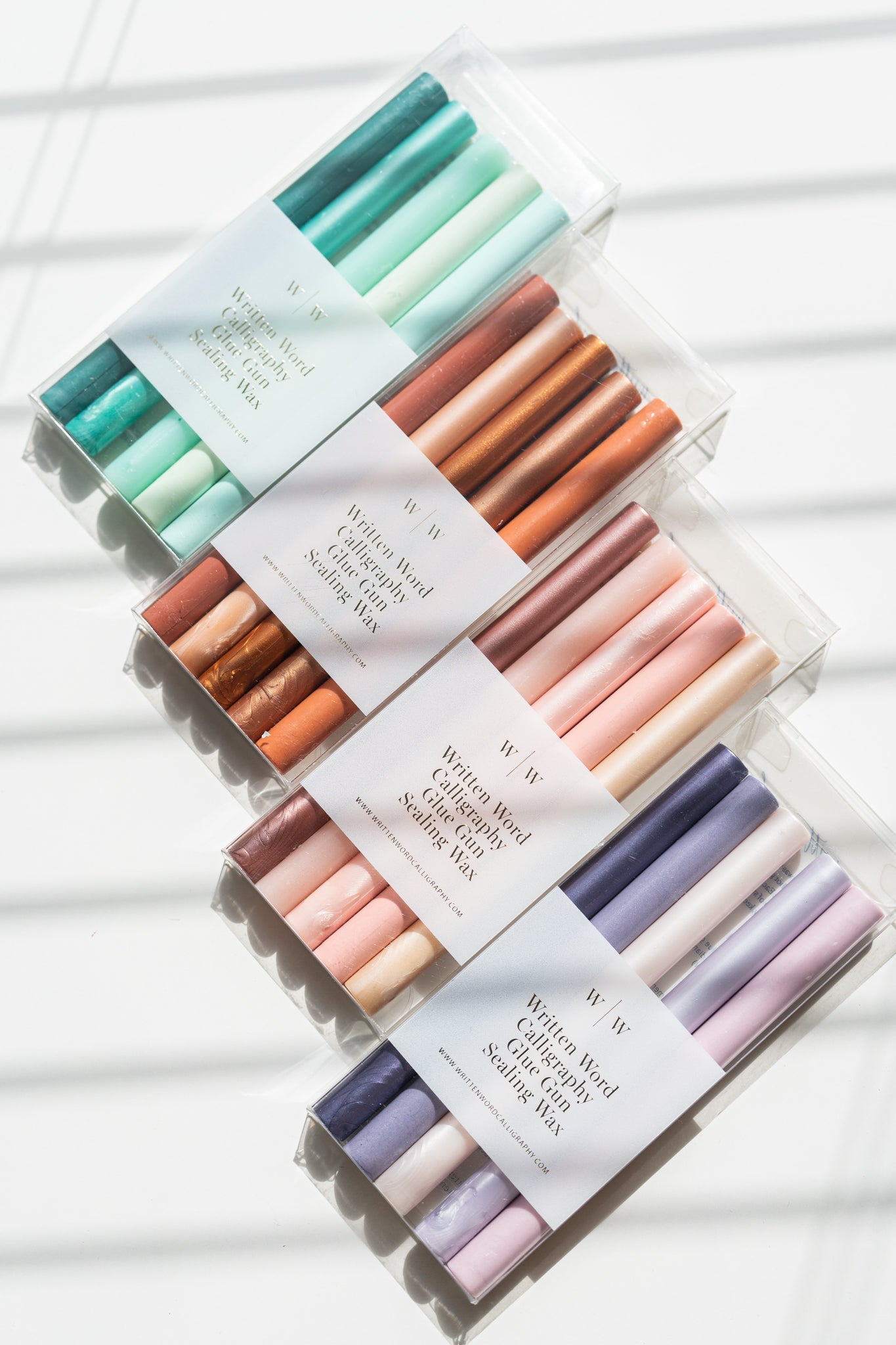 Four gradient sealing wax stick packs in pink, teal, purple, and rust, each with five coordinated shades.