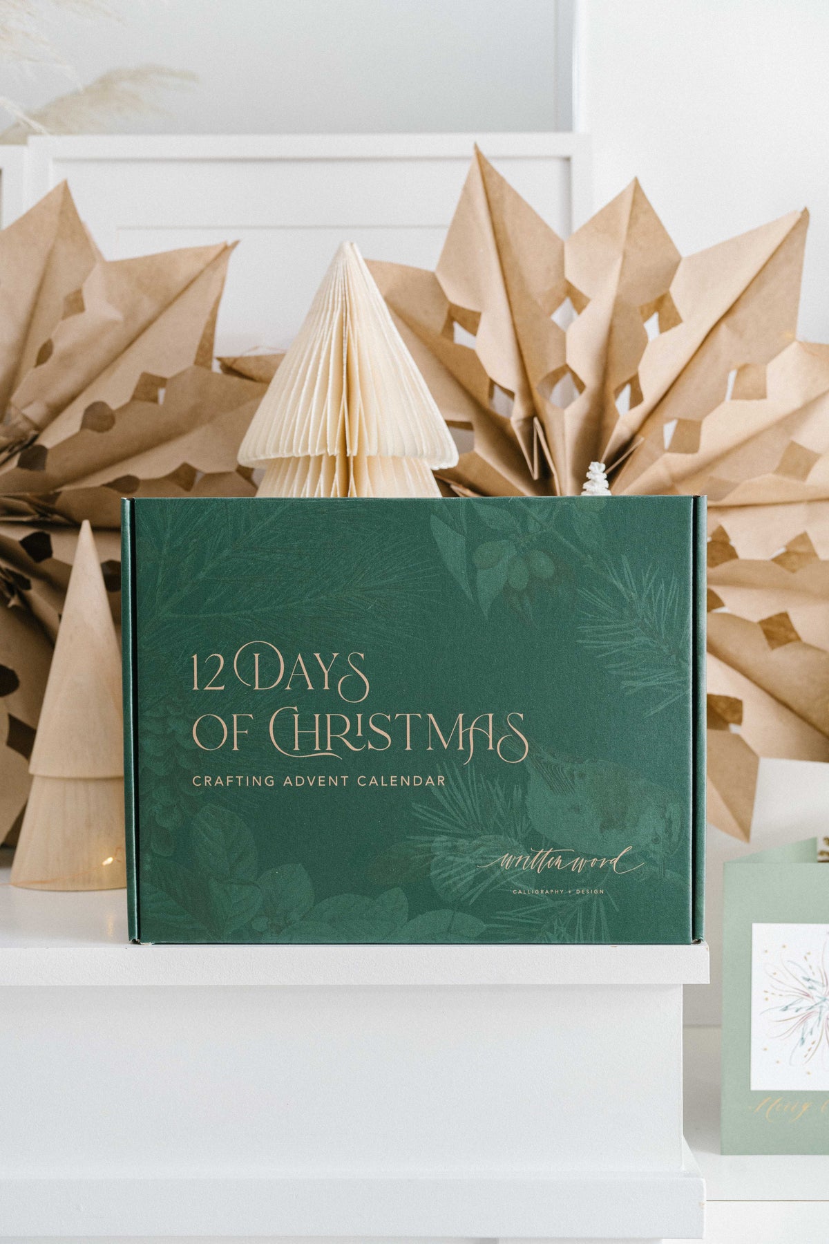 12 Days of Christmas crafting advent calendar box in green with gold lettering on holiday display