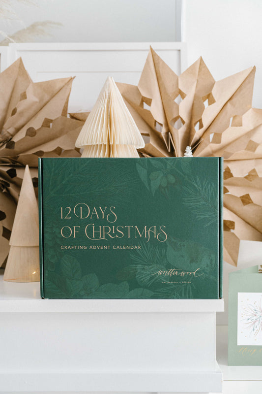 12 Days of Christmas crafting advent calendar box in green with gold lettering on holiday display