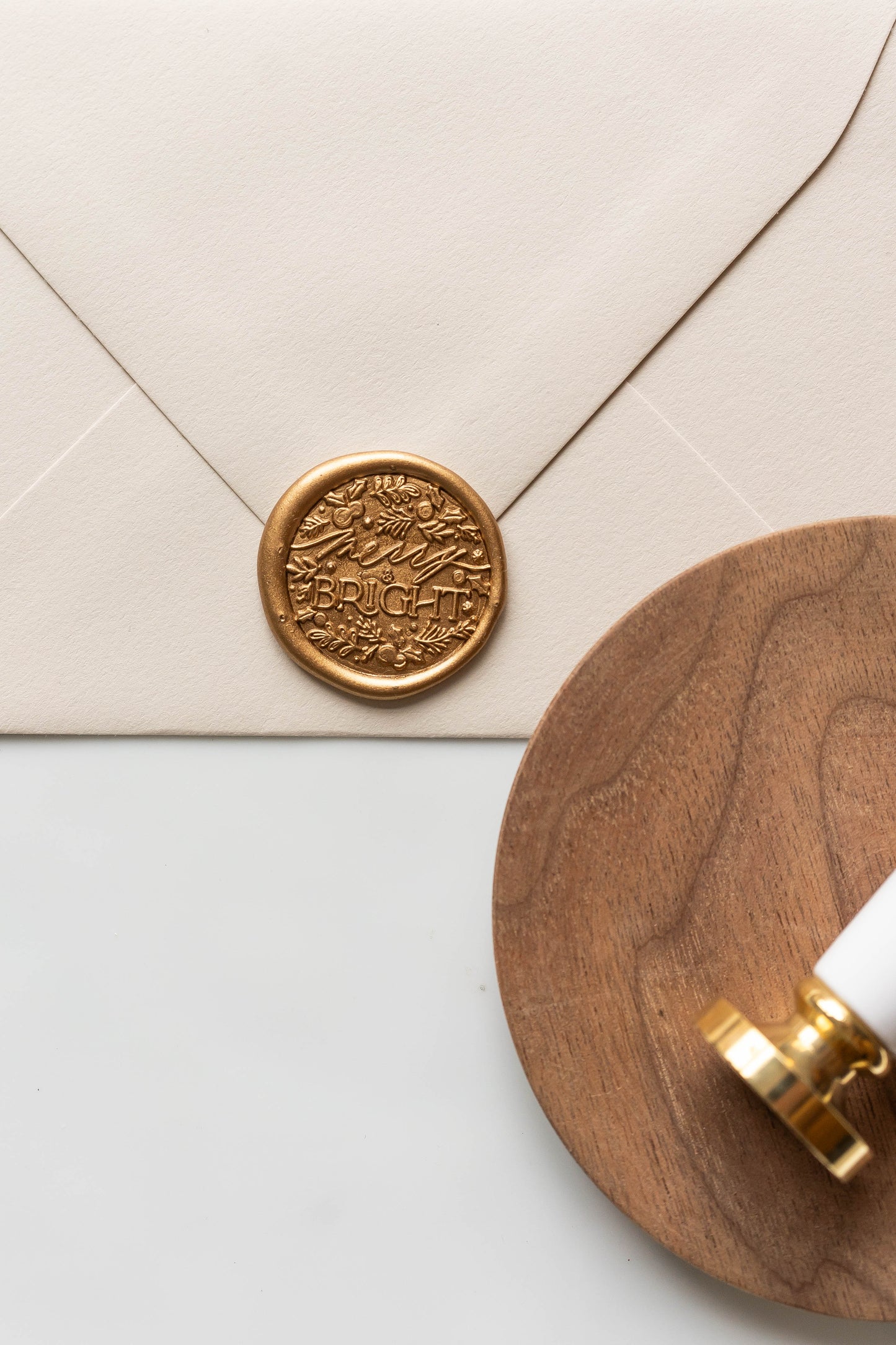 Gold wax seal on envelope with holiday script stamp, elegant wax sealing for cards and letters