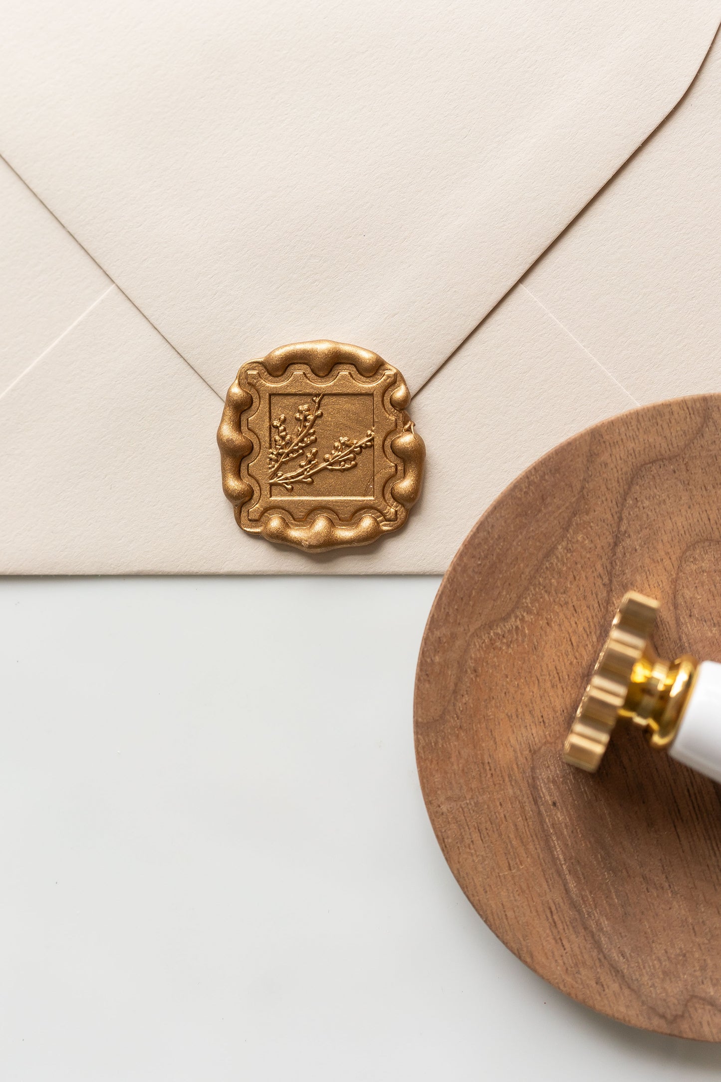 Gold winterberries wax seal on envelope with wooden tray styling, elegant wax seal for invitations and letters