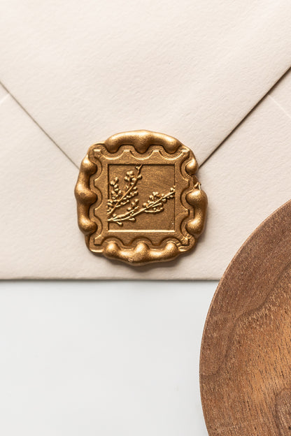 Close up of gold wax seal with winterberries stamp on envelope, classic wax seal for wedding stationery