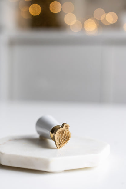 A festive ornament wax seal stamp, perfect for holiday greetings and gift wrapping.
