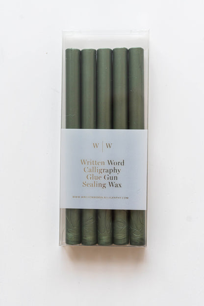 Emerald green glue gun sealing wax sticks in clear packaging for wax seals, invitations, holiday cards, envelope sealing, and paper crafts.