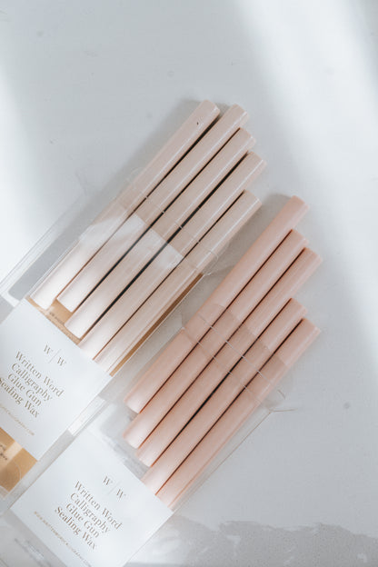 Comparison between a bundle of Sakura wax sticks and a bundle of Blush Wax Sticks on a light surface