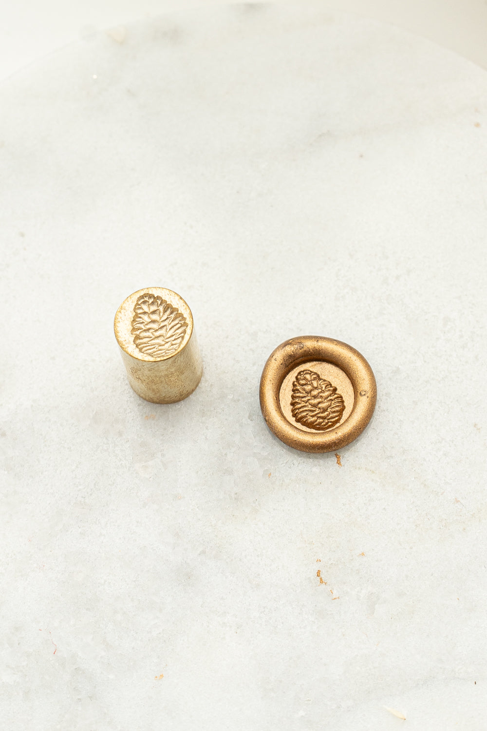 Pinecone wax seal stamp and gold wax impression for holiday envelopes and gift wrapping
