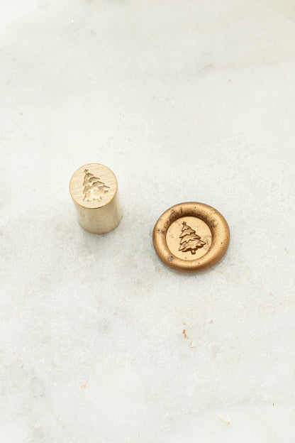 Close-up of mini wax seal stamp with a 3d illustration of a Christmas Tree