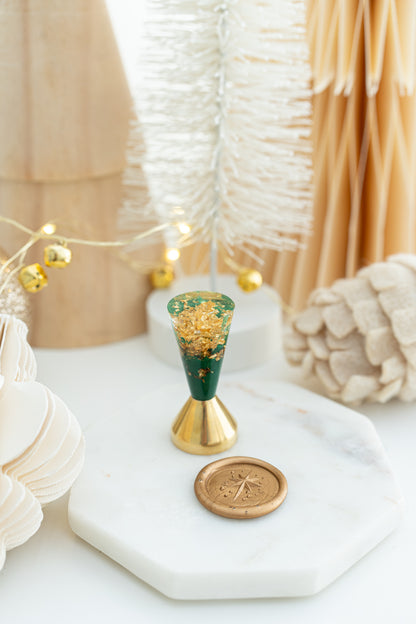 Star of Bethlehem wax seal stamp with green resin handle and gold flakes, limited edition holiday design.