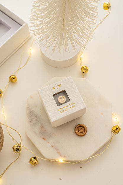 Boxed mini wax seal stamp with angel design and gold wax impression, part of Written Word Calligraphy’s Holiday Collection