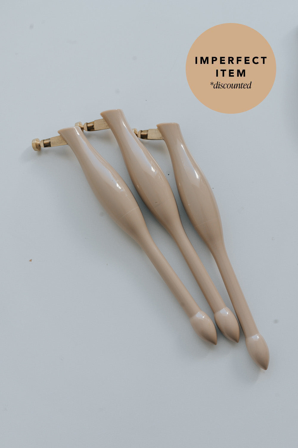 Three beige universal nib and container pens on a white background with 'imperfect item' label.