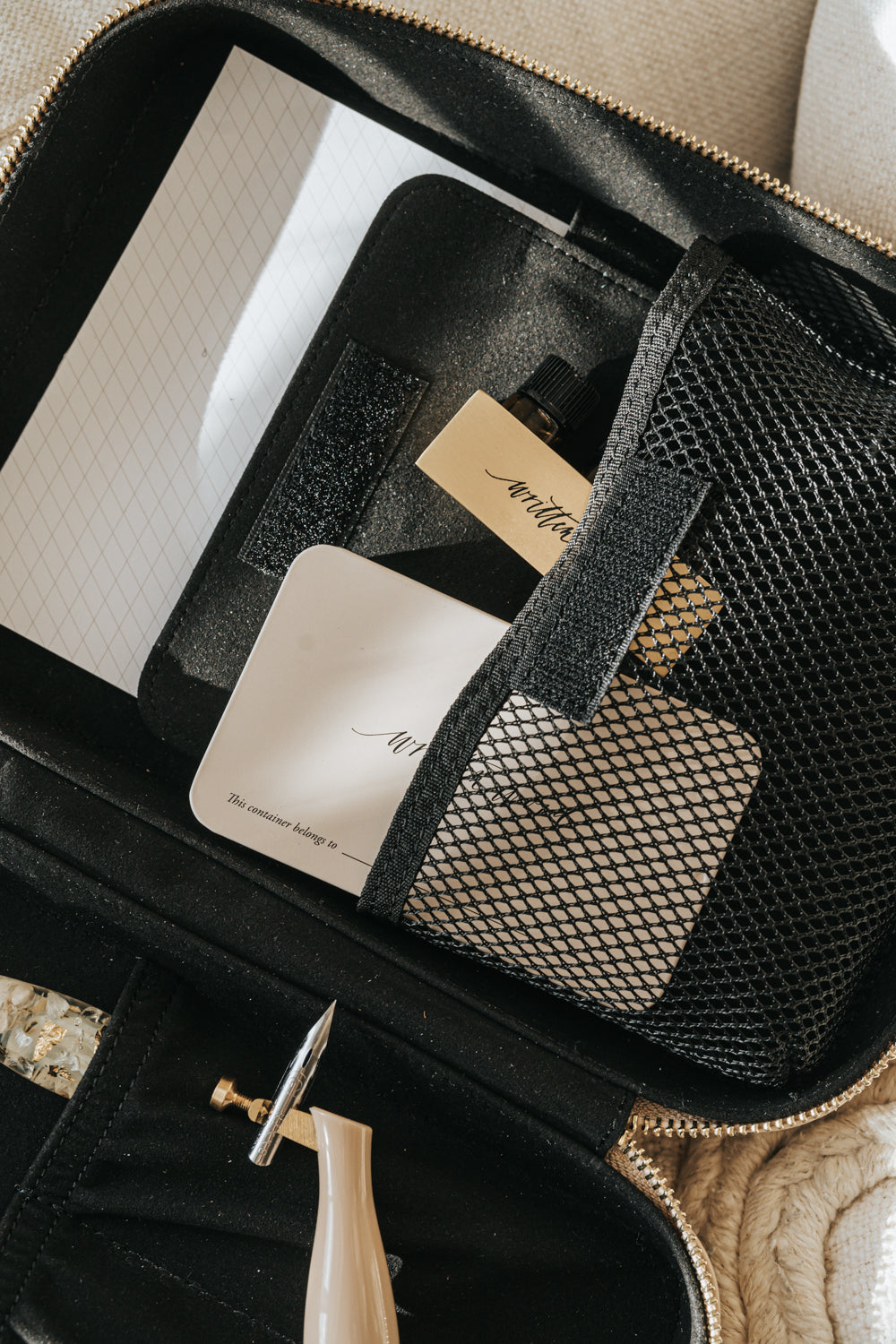 A calligraphy travel kit opened and filled with calligraphy supplies 