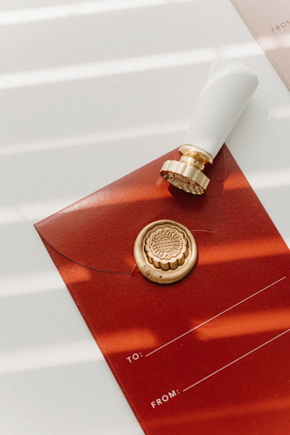 Mooncake wax seal stamp with gold seal on red Mid-Autumn Festival gift envelope with to and from lines