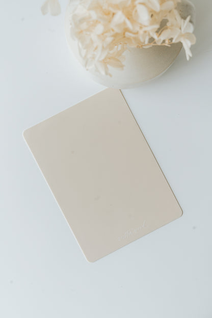 Mini silicone mat for wax sealing on white surface with dried florals in bowl