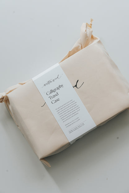 Packaged calligraphy travel case in cream dust bag, portable organizer for calligraphy and stationery supplies