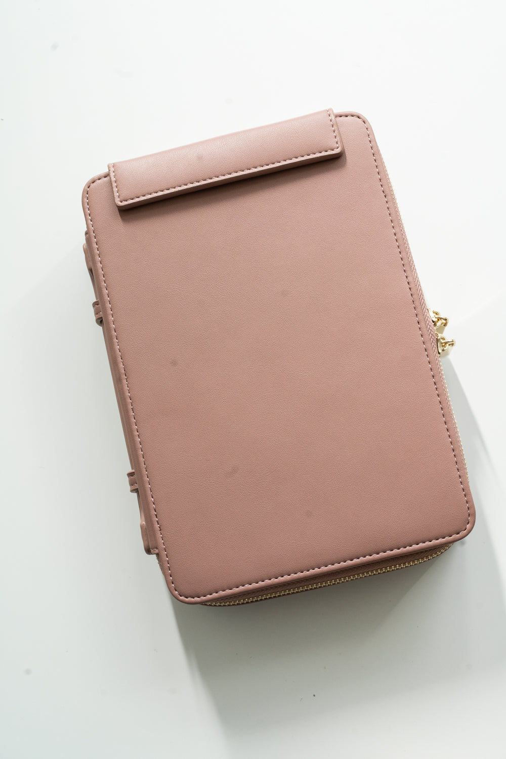 Closed dusty rose vegan leather travel case with gold zipper, compact storage for calligraphy tools and pens