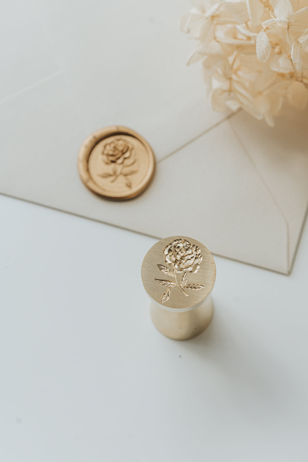 Brass peony wax seal stamp for wedding invitations with gold wax seal and dried hydrangea flowers