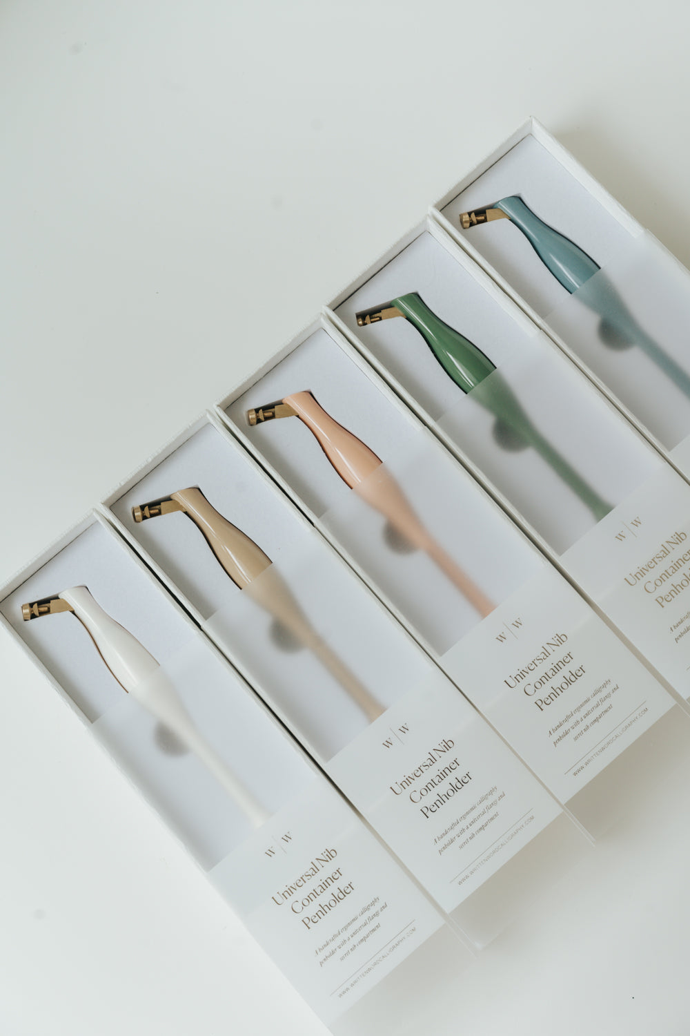 Collection of universal oblique calligraphy pen holders in five colors for pointed pen calligraphy by Written Word Calligraphy.