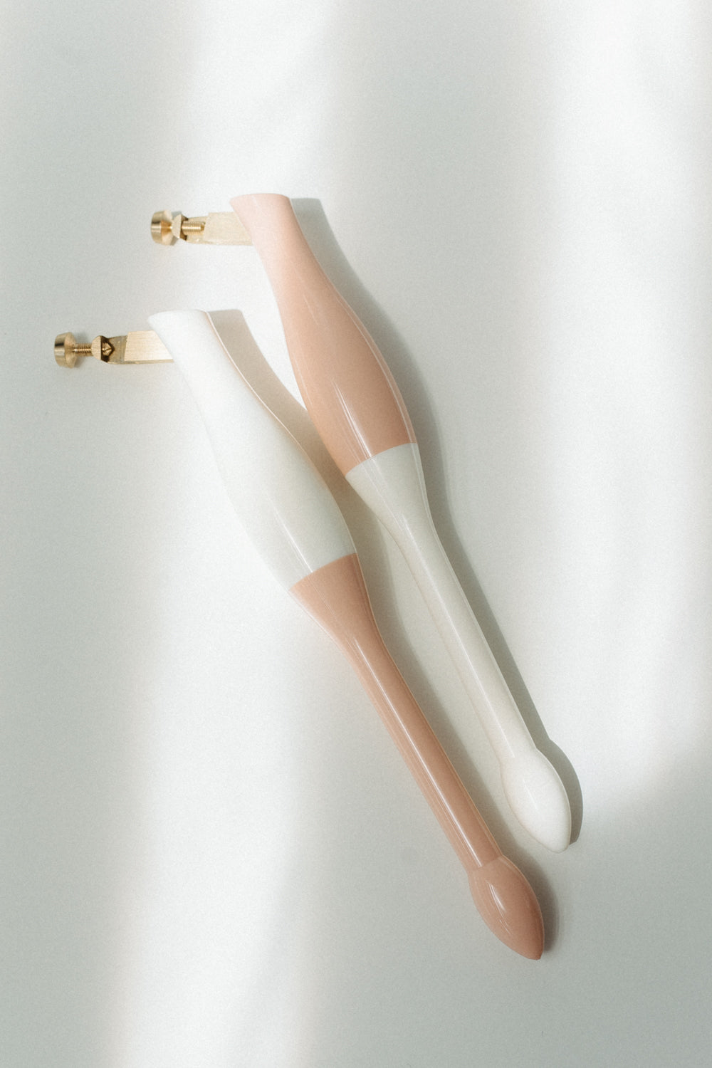 Pair of universal calligraphy pen holders in blush and white designed for left- and right-handed calligraphers.