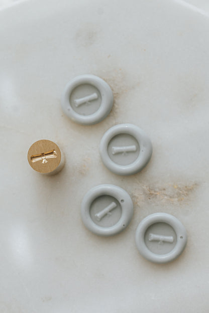 Set of pale gray graduation diploma mini wax seals with brass stamp head