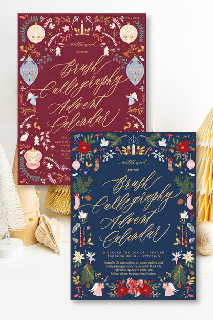 Brush Calligraphy Advent Calendar Volume I and Volume II bundle, burgundy and navy covers with festive illustrations and gold lettering by Written Word