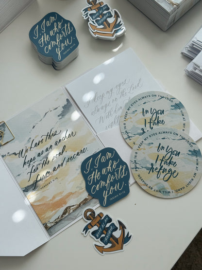 September Scribe Christian snail mail kit flat lay with Hebrews 6:19 Hope as an Anchor watercolor card, Psalm 16:8 In You I Take Refuge coasters, Isaiah 51:12 sticker and anchor sticker