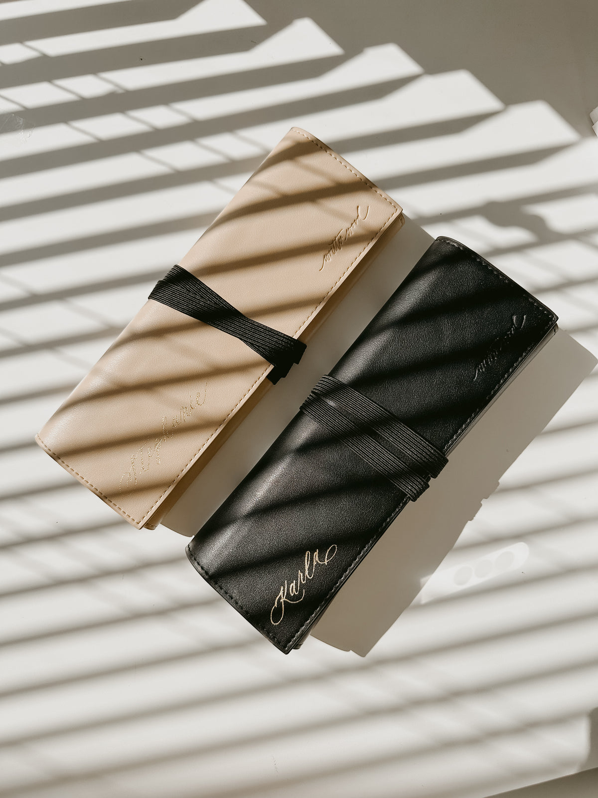 Custom engraved vegan leather pen rolls in beige and black with handwritten calligraphy names, personalized gift for artists, calligraphers, writers, teachers, and stationery lovers.