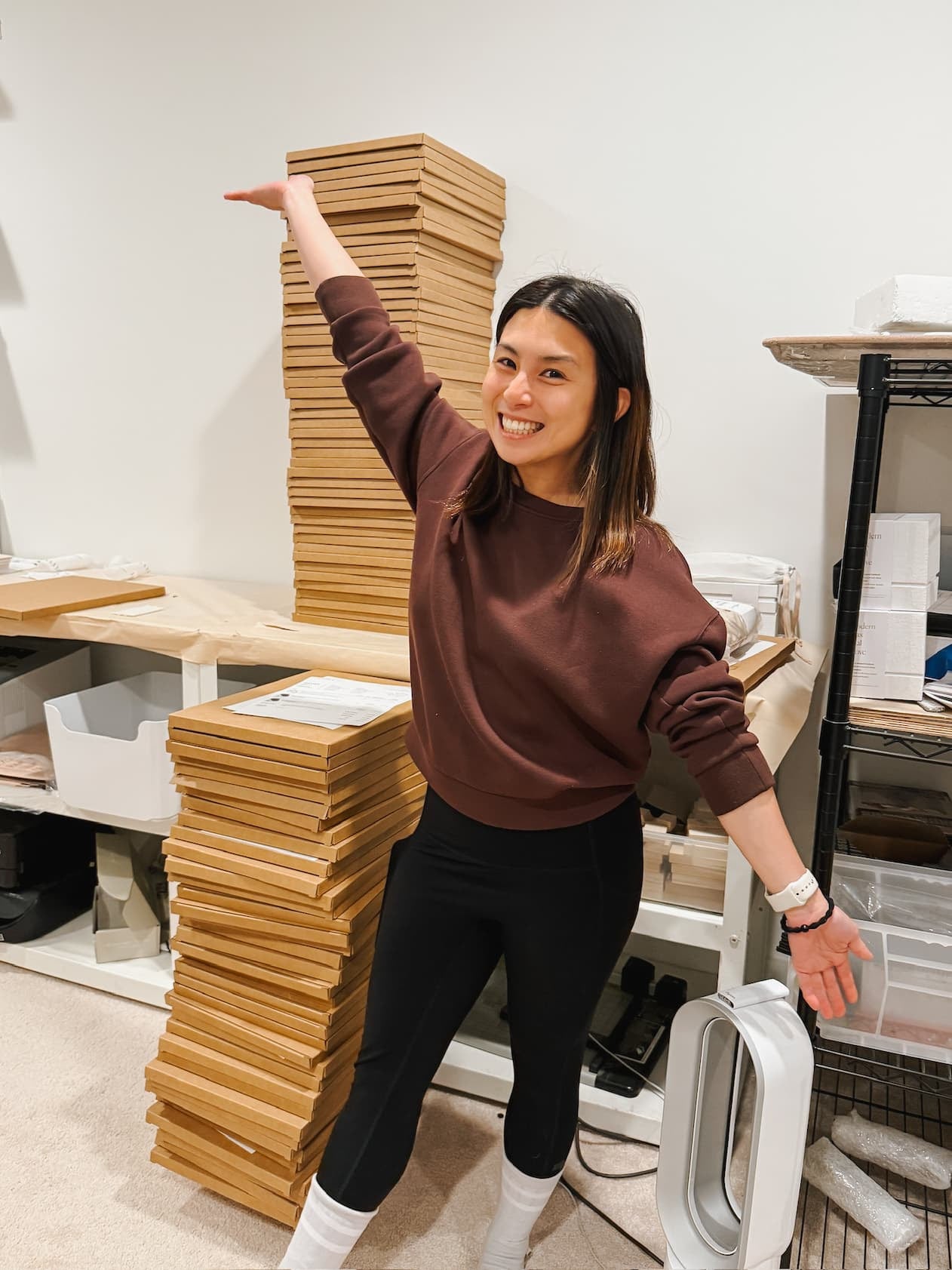 Karla standing next to a stack of Brush Calligraphy Advent Calendars for holiday gifting and creative learning.