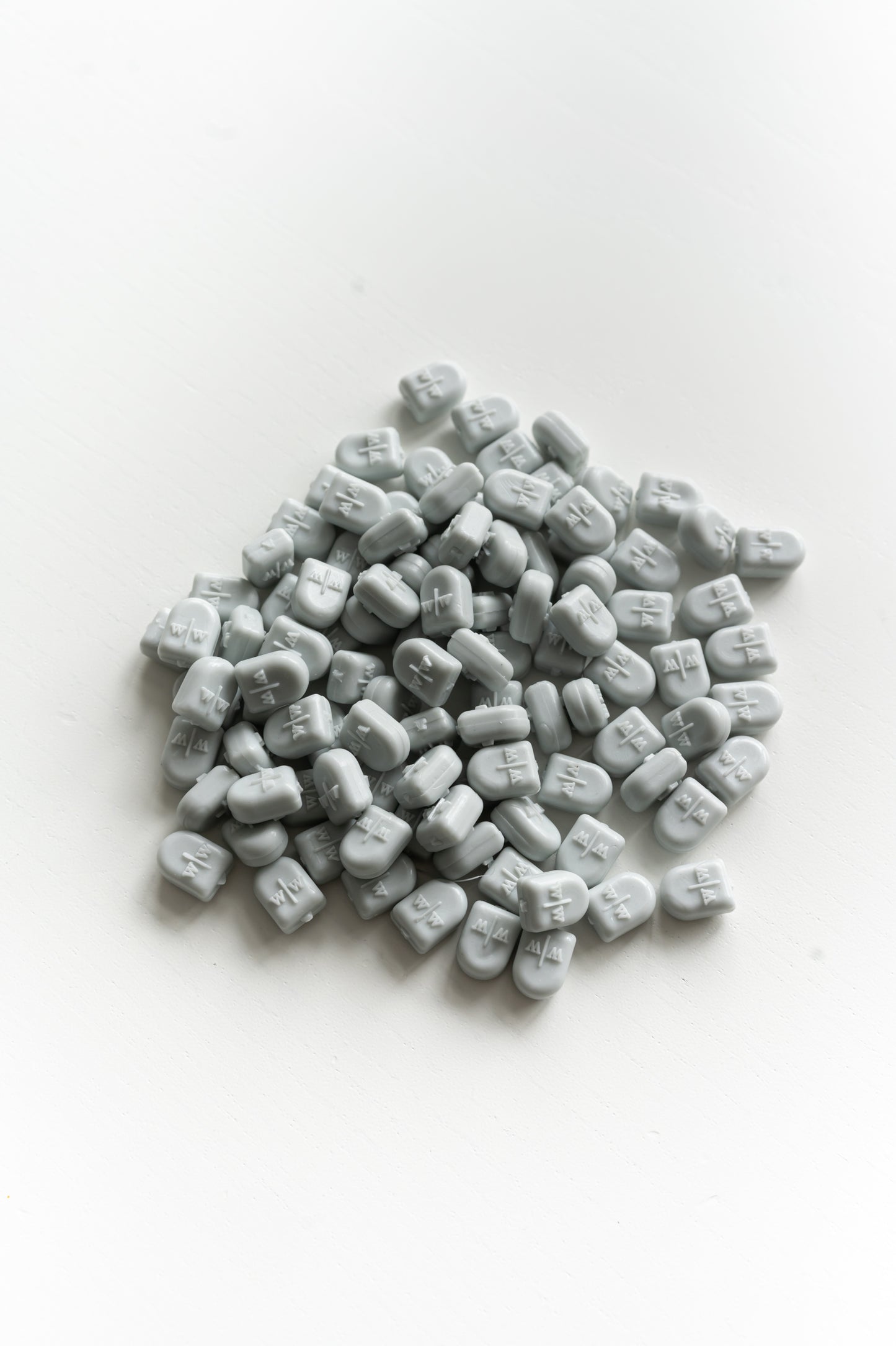 Pale grey wax seal beads close up for melting and creating wax seals on envelopes