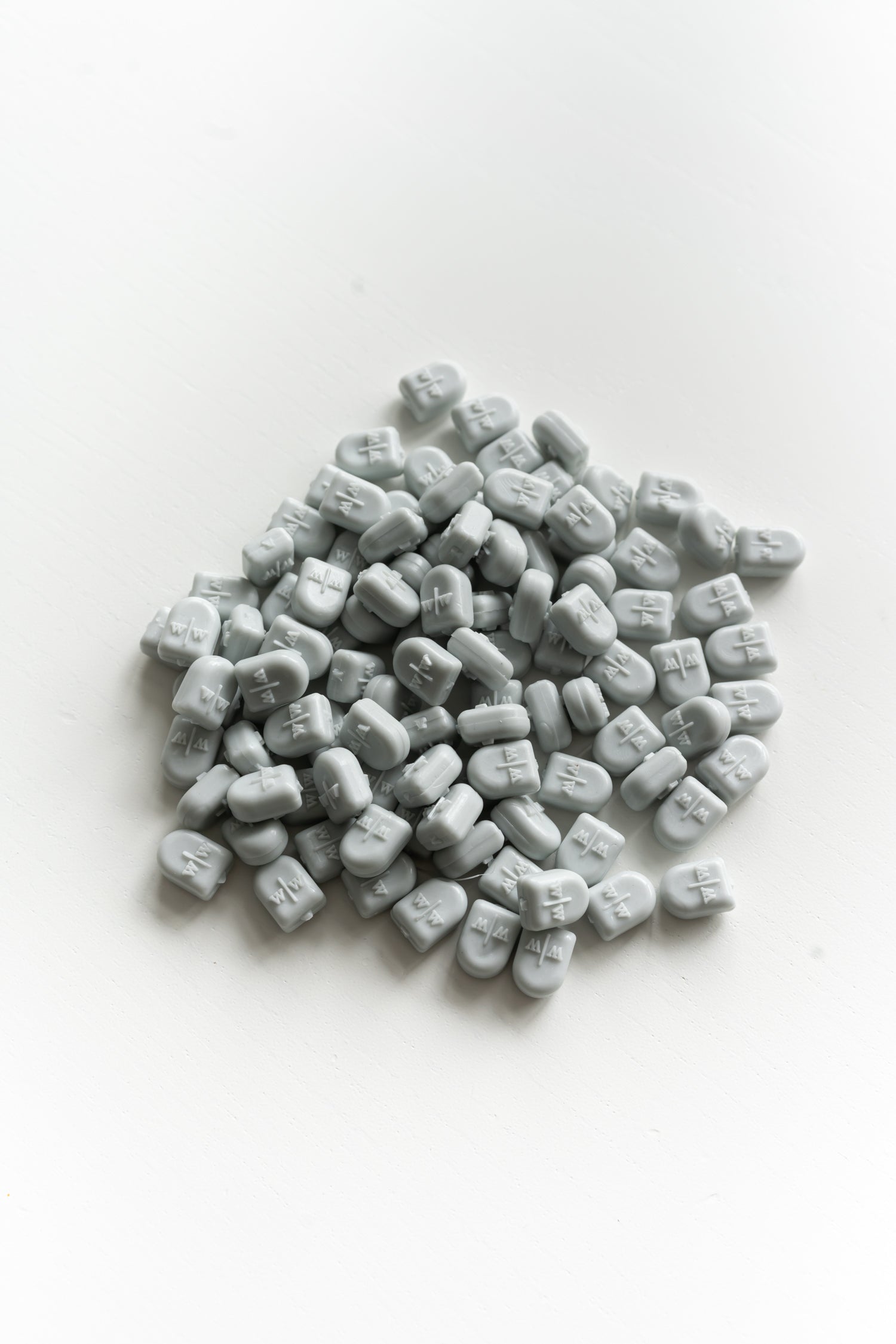 Pale grey wax seal beads close up for melting and creating wax seals on envelopes