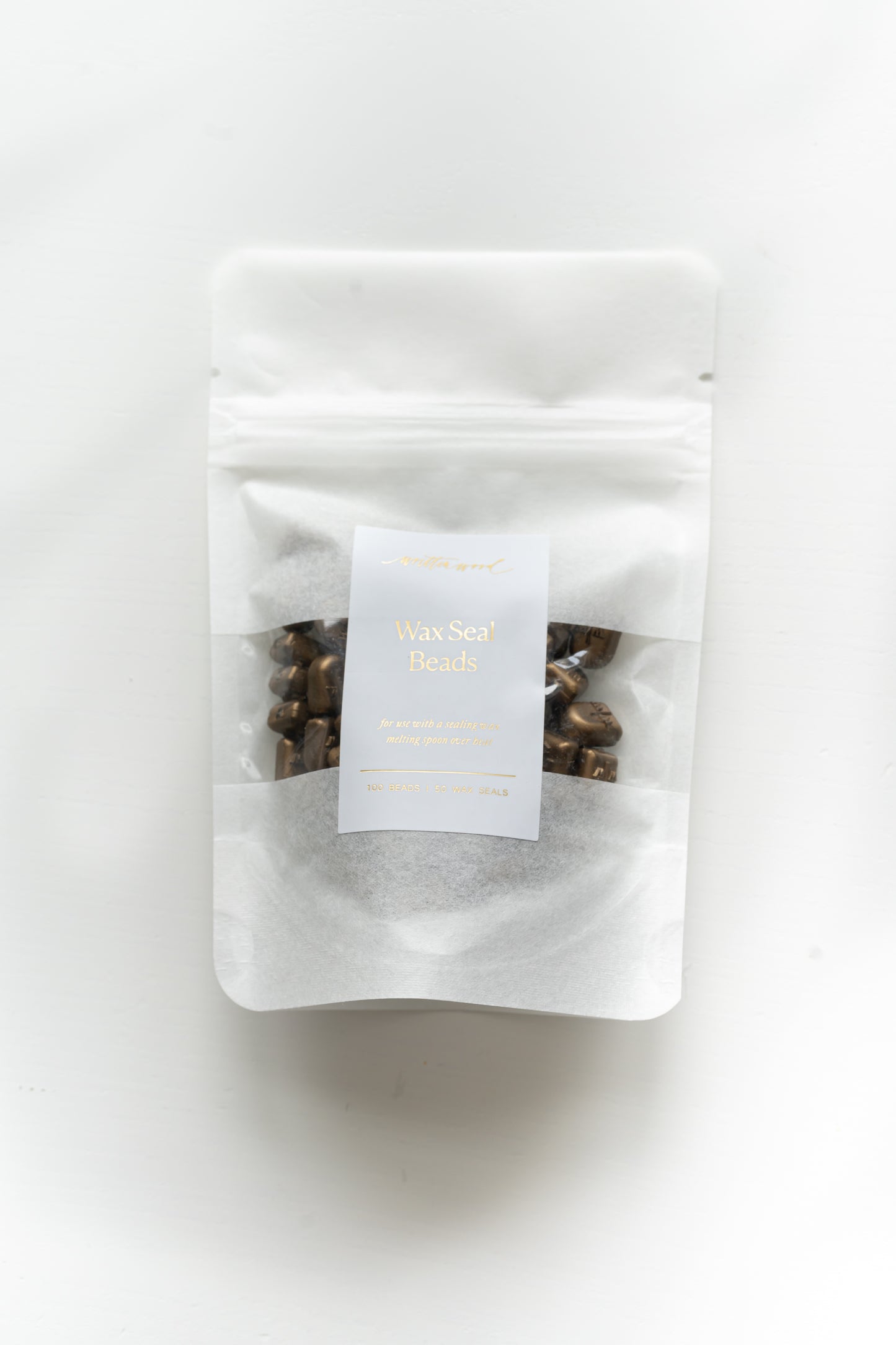 Packaged gold wax seal beads in resealable pouch for wax seal stamping
