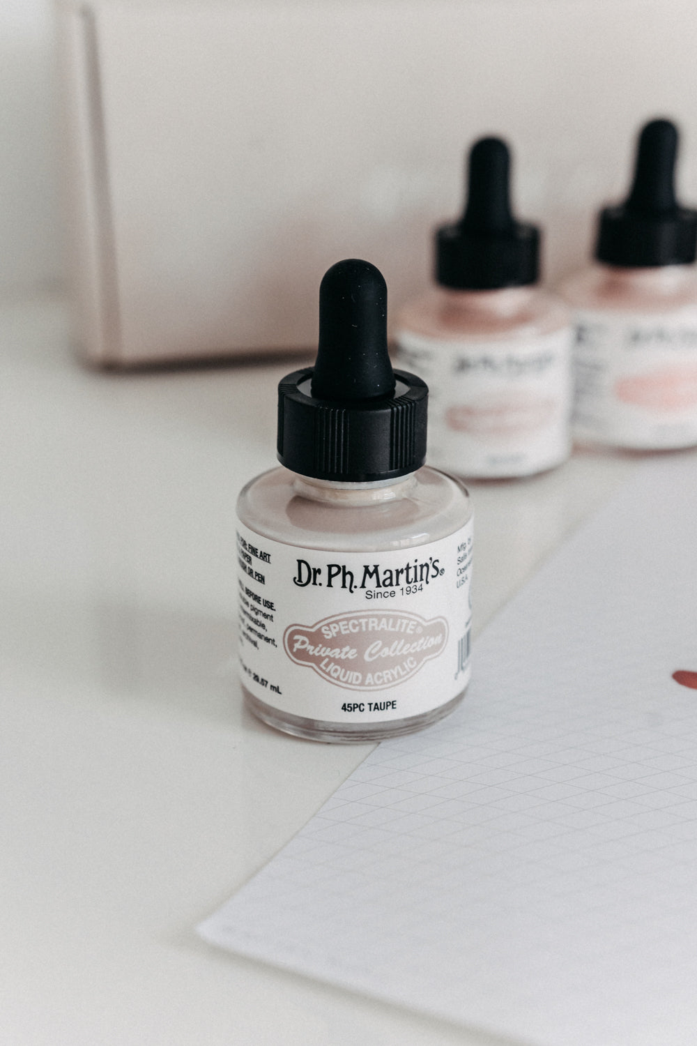 Close-up of Dr. Ph. Martin's Spectralite Private Collection liquid acrylic ink in taupe, featuring its elegant label design