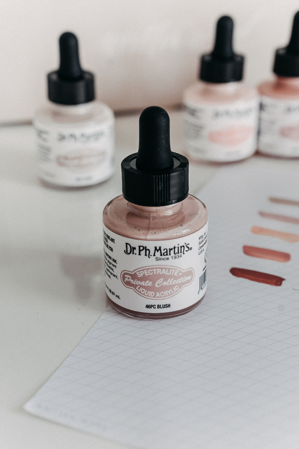 Dr. Ph. Martin's Spectralite Private Collection liquid acrylic ink in blush, with swatches on paper showcasing the color.
