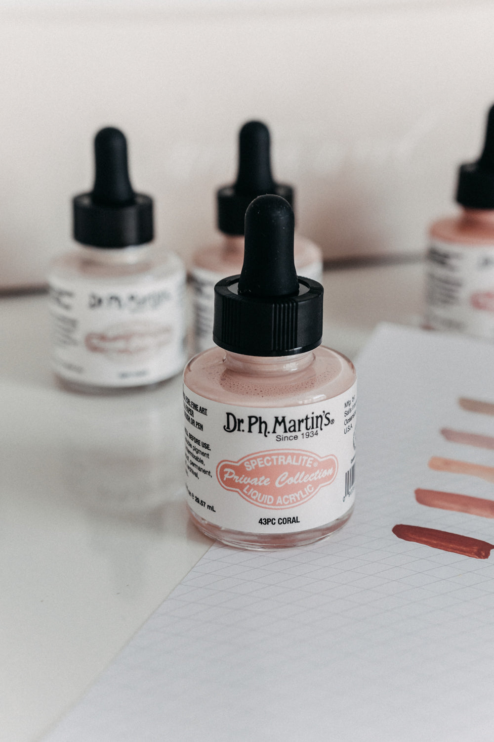 Dr. Ph. Martin's Spectralite Private Collection liquid acrylic ink in coral, with swatches on paper showcasing the color