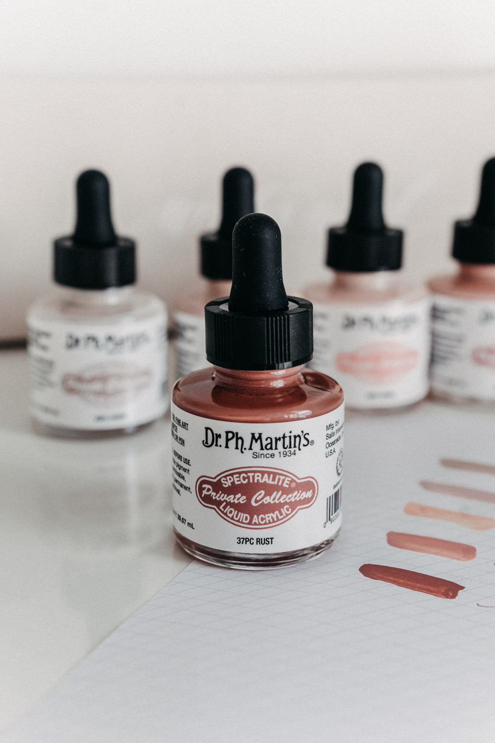 Dr. Ph. Martin's Spectralite Private Collection liquid acrylic ink in rust, with swatches shown on grid paper