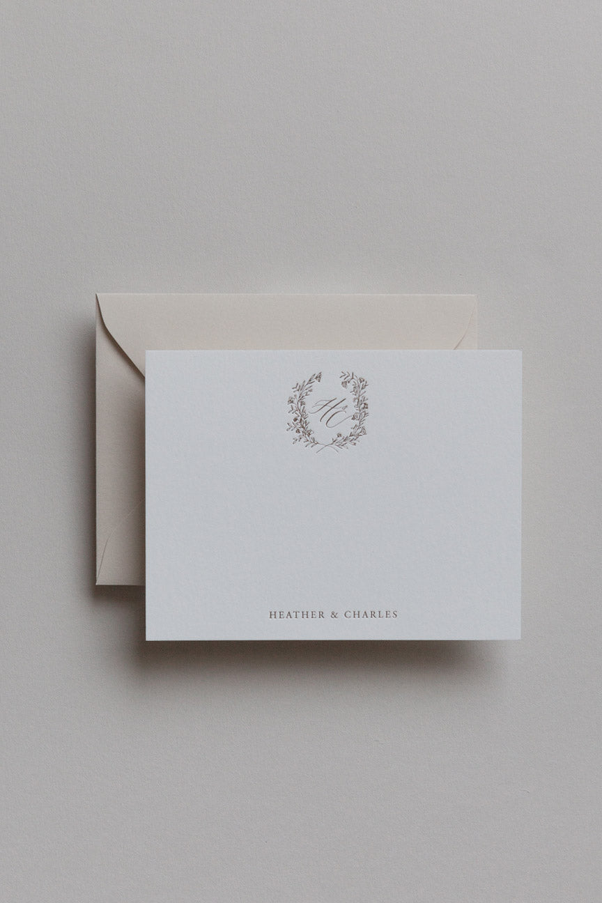 Minimalist personalized stationery with gold monogram crest and neutral envelope set