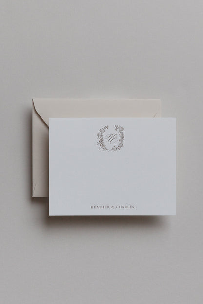 Minimalist personalized stationery with gold monogram crest and neutral envelope set