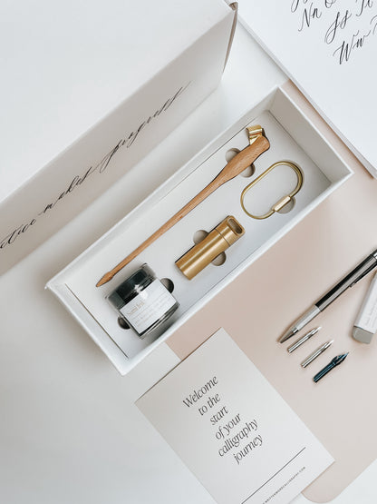 Calligraphy starter kit including nibs, ink, pen holder, guide, and a welcome card to begin your calligraphy journey