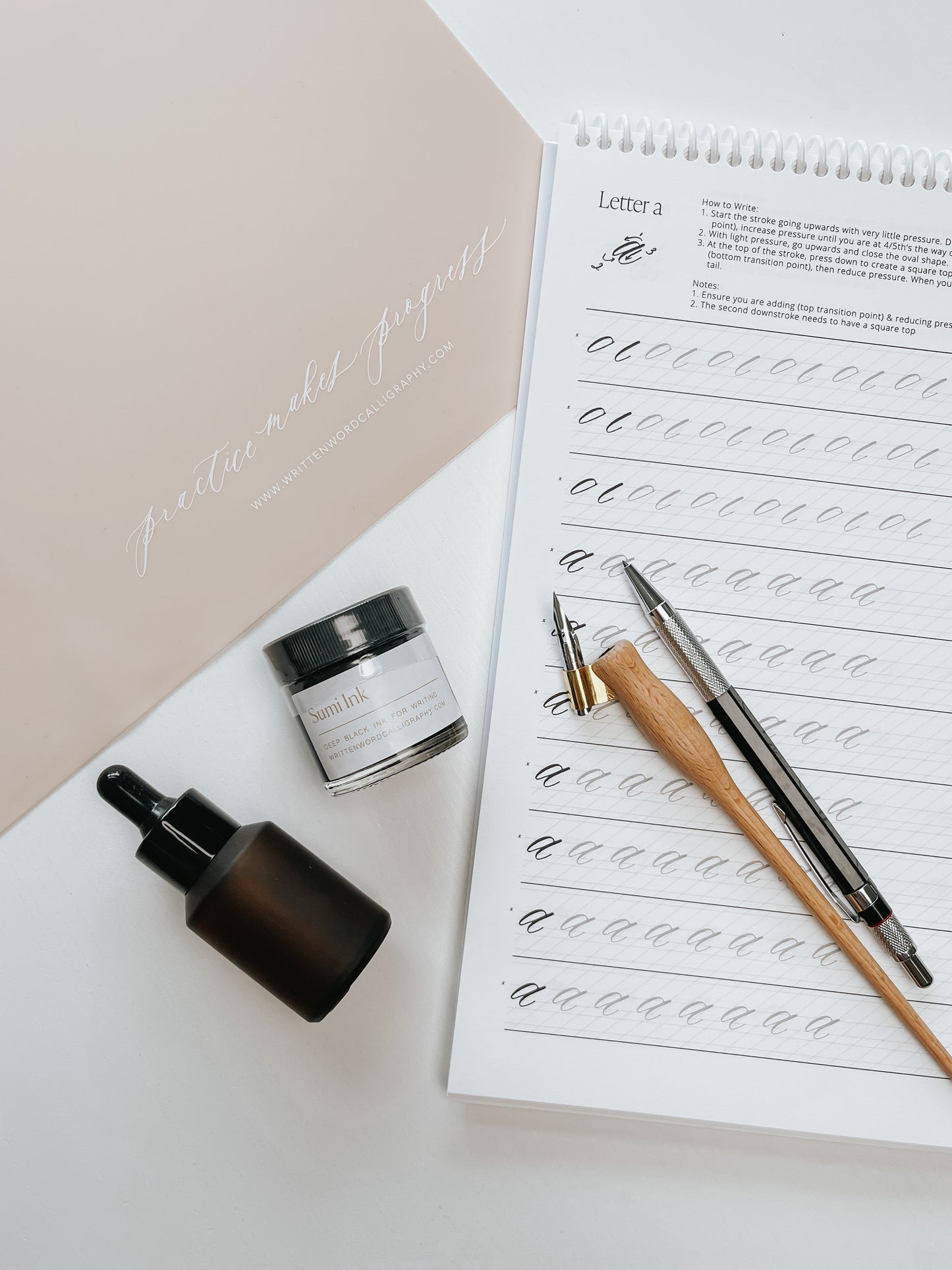 Sumi ink, dip pen holders, nibs, and calligraphy guide for practicing modern calligraphy strokes