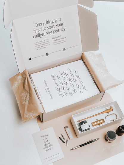 Calligraphy starter kit with guide, ink, nibs, pen holder, and tools to begin your calligraphy journey
