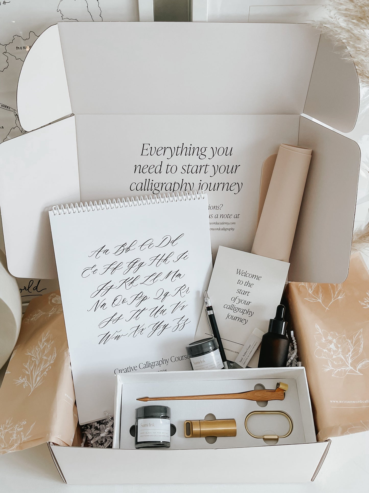 Calligraphy starter kit with tools, ink, practice pad, and welcome card to begin your calligraphy journey