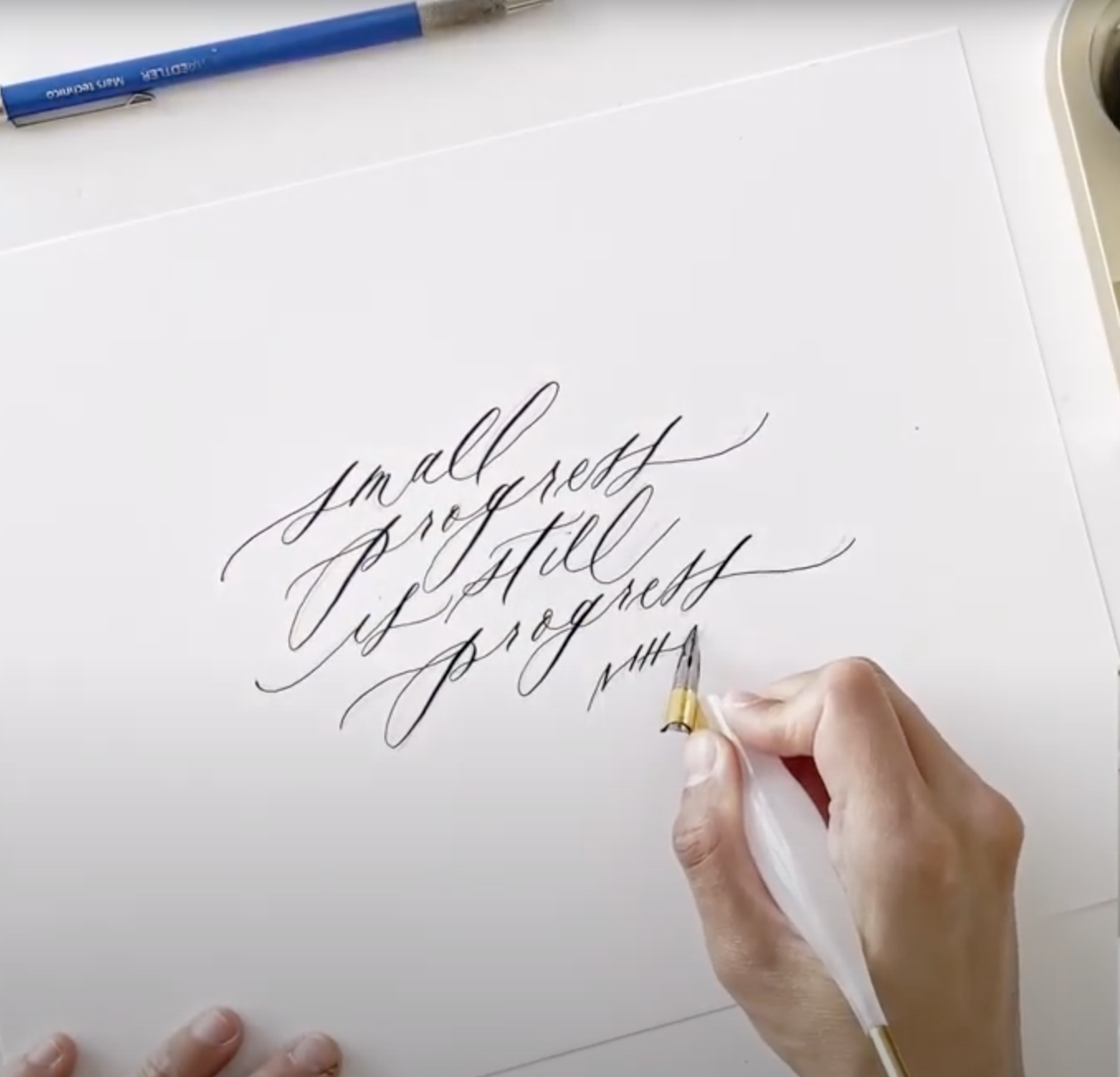 Hand lettering modern calligraphy with oblique pen and black ink on white paper