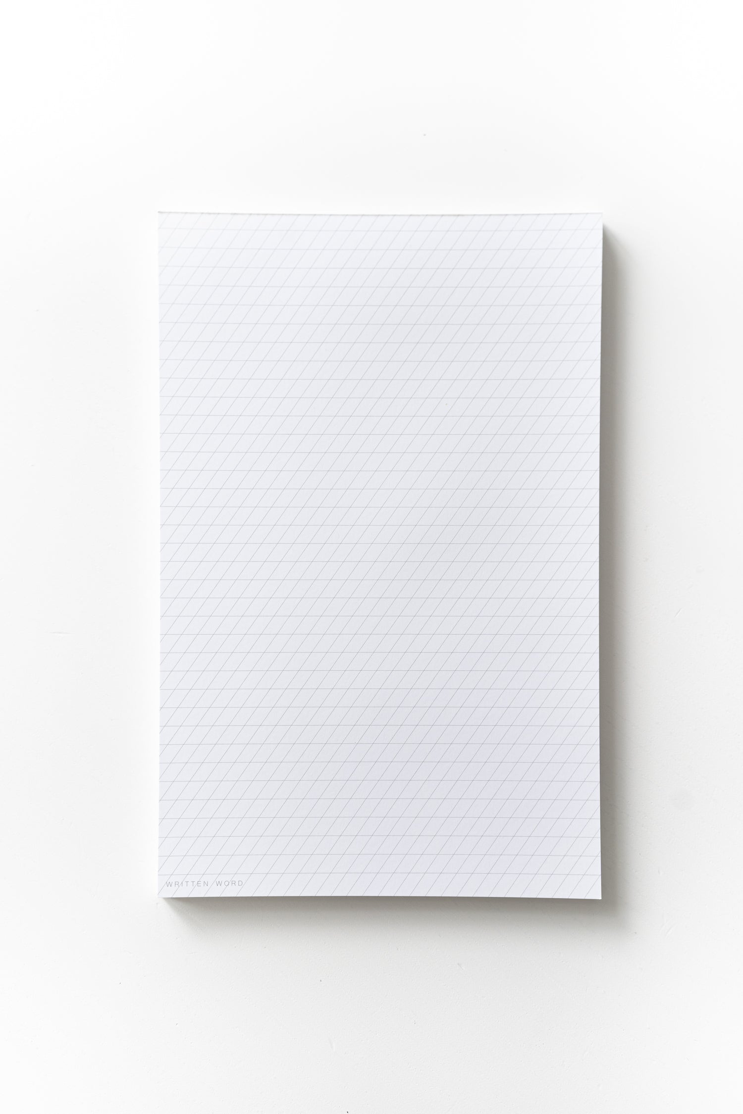 Slanted guide notepad with a 55-degree slant, featuring 50 ink-friendly sheets for calligraphy practice
