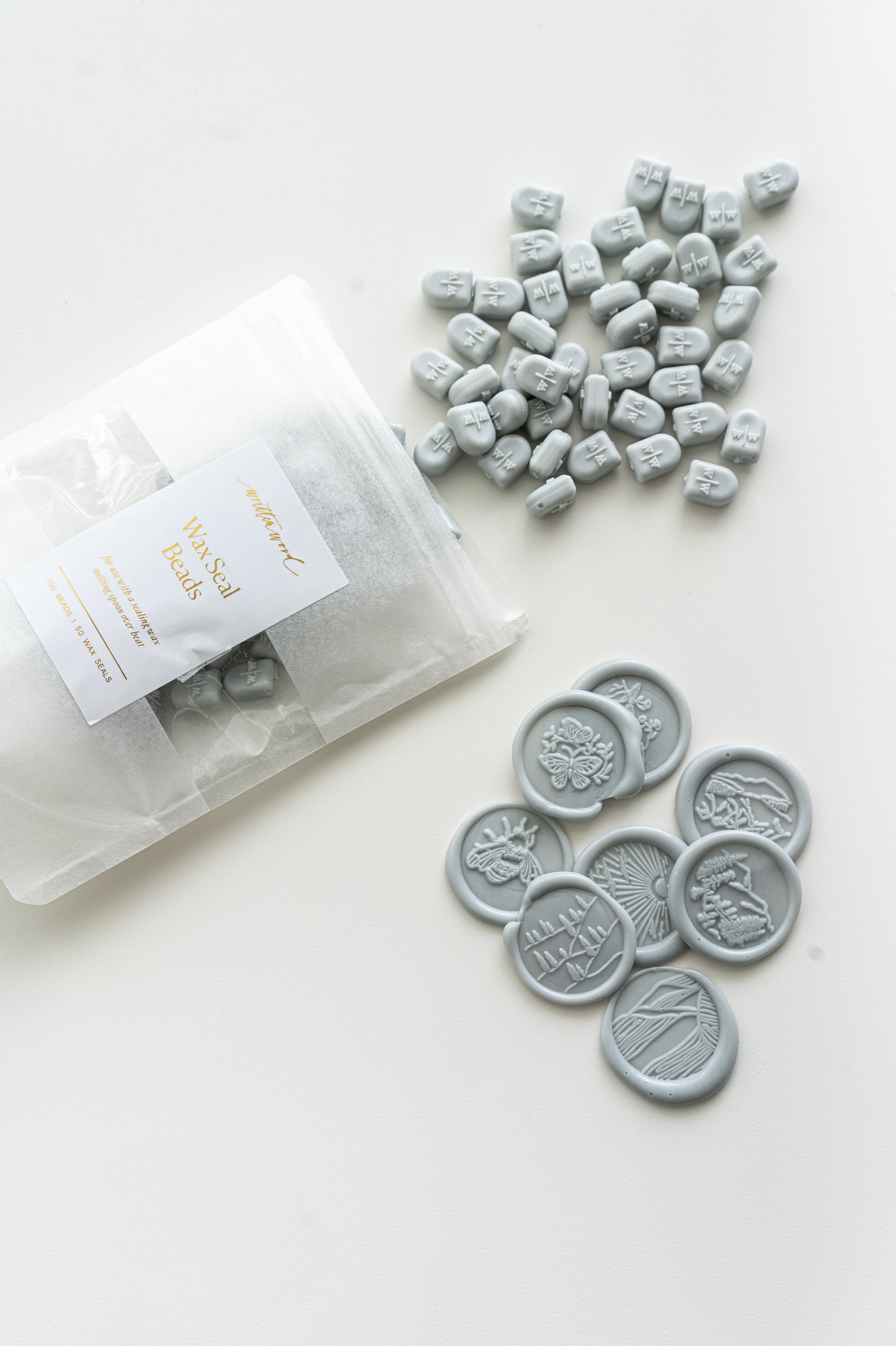 Pale grey wax seal beads with finished wax seals for wedding invitations and stationery
