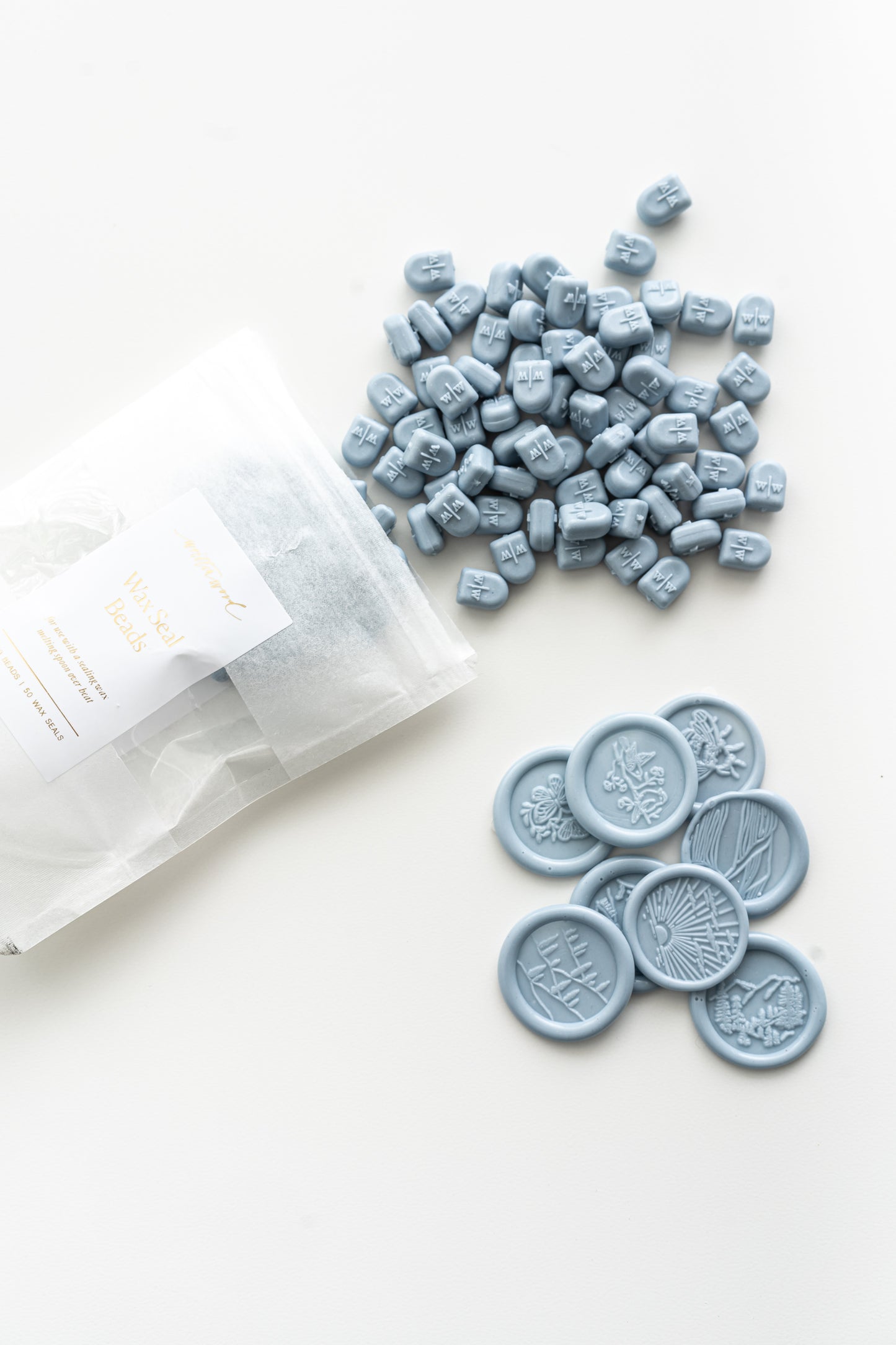 Dusty blue wax seal beads with finished wax seals for wedding invitations and stationery
