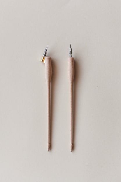 Two dual-purpose calligraphy pens with wooden bodies, shown with straight and oblique brass flanges, ideal for modern calligraphy