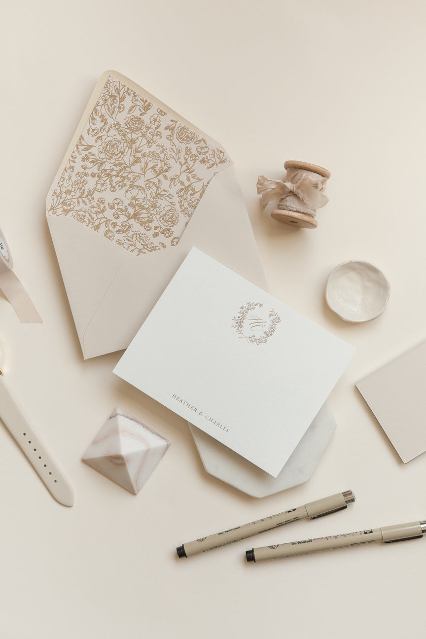 Custom monogram note cards with gold foil wreath and minimalist calligraphy on textured paper