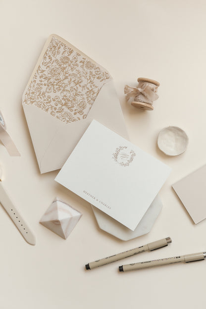 Custom monogram note cards with gold foil wreath and minimalist calligraphy on textured paper