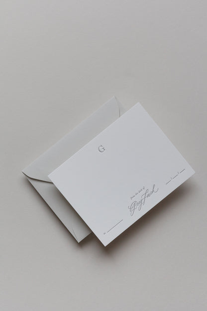 Personalized stationery card with embossed initial and envelope in neutral minimalist style